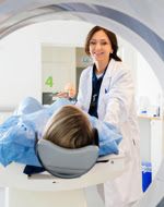 Physician and patient preparing for use of the Computed Tomography (CT) scanner.